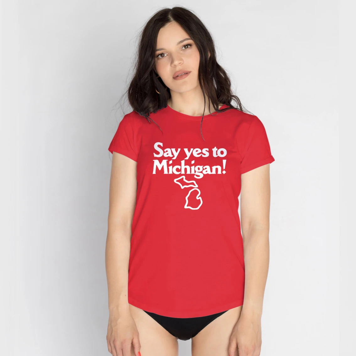 A woman is wearing a red t-shirt with 'Say yes to Michigan!' text and Michigan map on it against a plain background