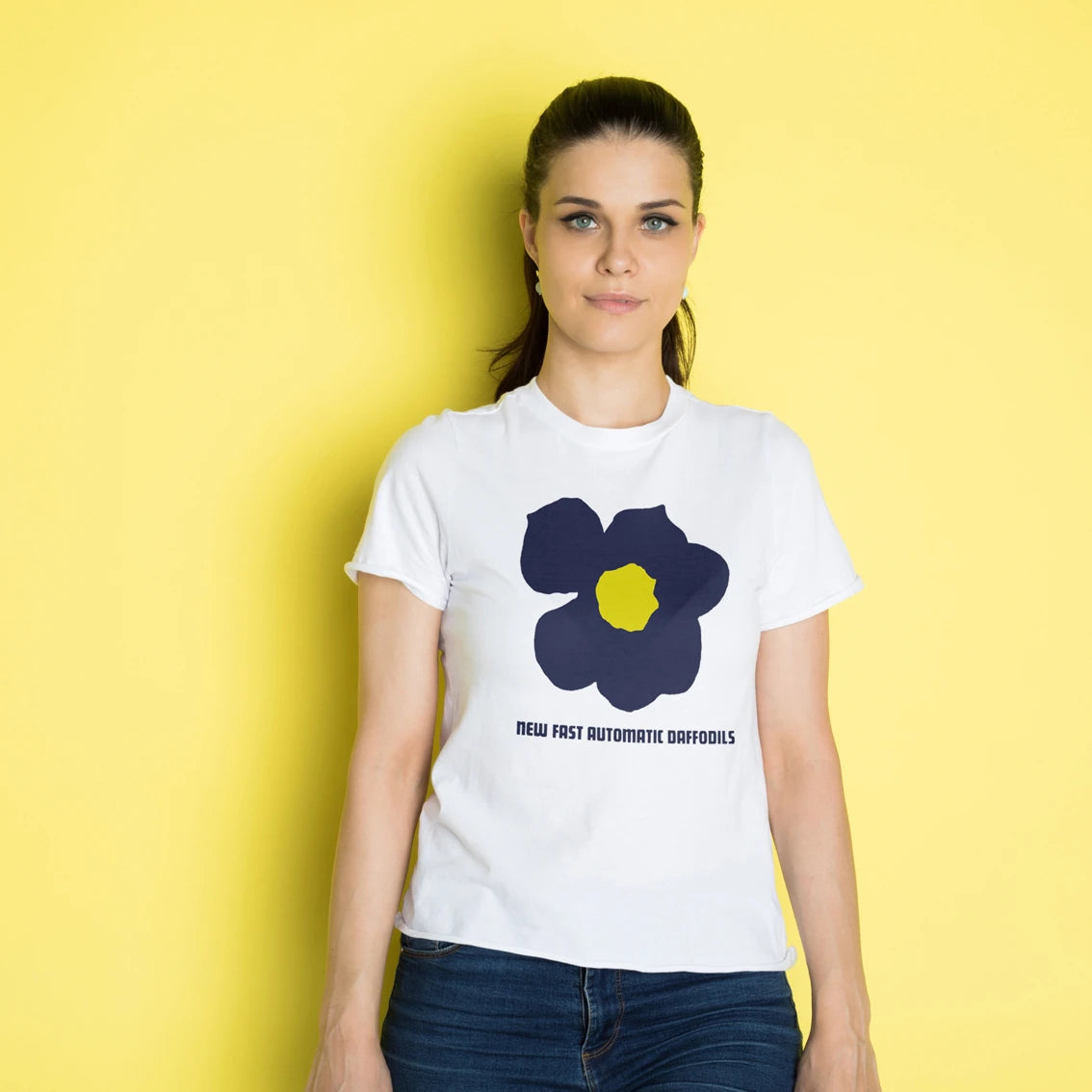 Woman wearing a white t-shirt with a blue and yellow flower design and 'New Fast Automatic Daffodils' text on a yellow background