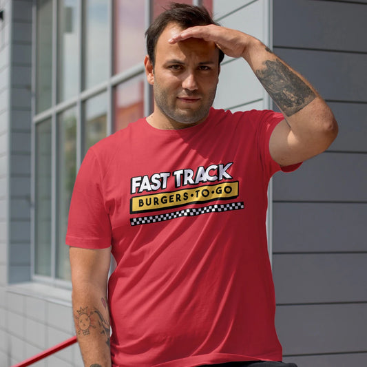 A man is wearing a red 'Fast Track Burgers to Go' t-shirt outdoors.