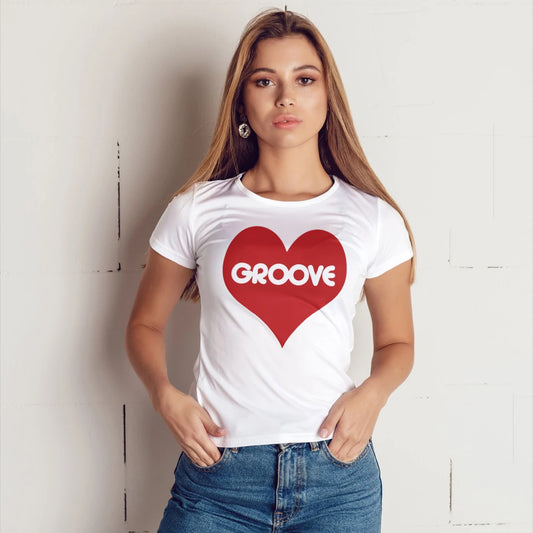 A woman is wearing a white t-shirt with a red heart and 'GROOVE' text against a plain background