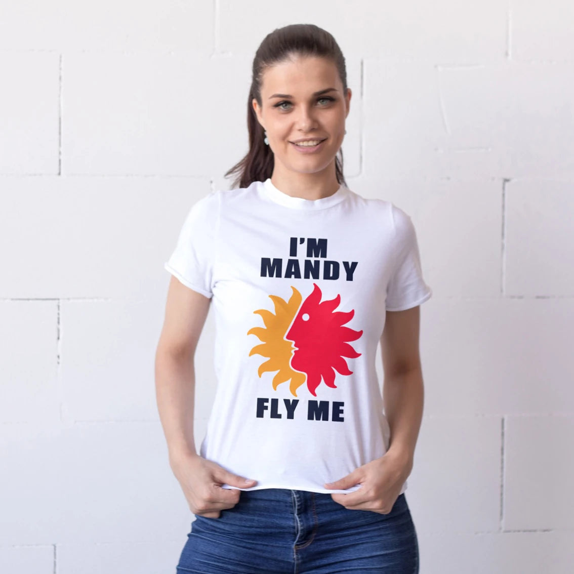 A woman is wearing a white t-shirt with colorful design of the sun and 'I'm Mandy - Fly Me' text against a white background