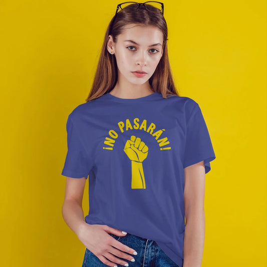 A woman is wearing a blue t-shirt with a yellow picture of the fist hand and 'NO PASARÁN' text against a yellow background