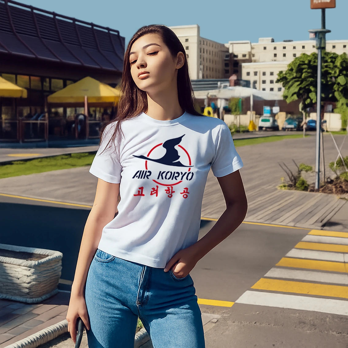 Woman wearing a white t-shirt with 'Air Koryo' logo outdoors.