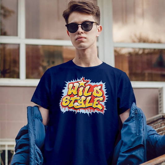 Man in sunglasses wearing a blue t-shirt with 'Wild Style' graphic, standing outdoors.