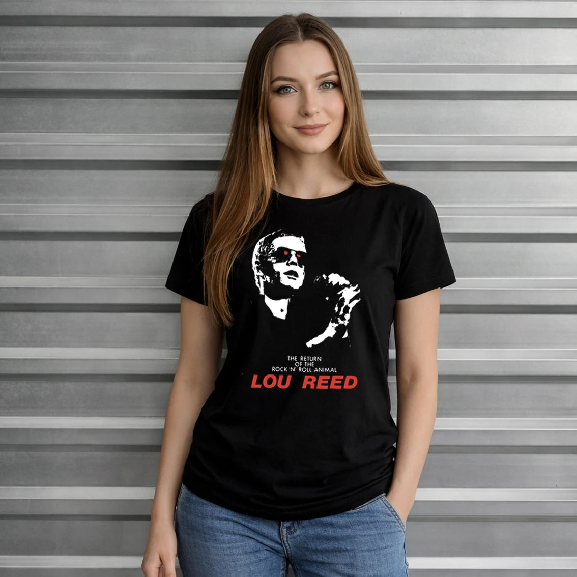 Woman wearing a black t-shirt with a graphic and 'Lou Reed ' text, standing against a gray metal background