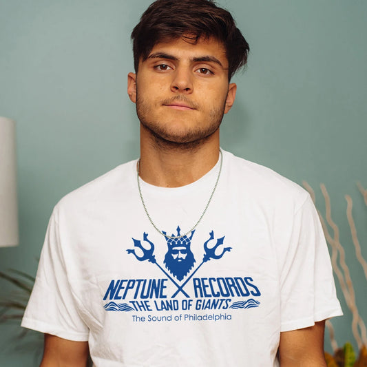 Man wearing a white t-shirt with Neptune Records, The Land Of Giants logo