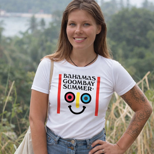 Woman wearing a white t-shirt with 'Bahamas Goombay Summer' design outdoors.