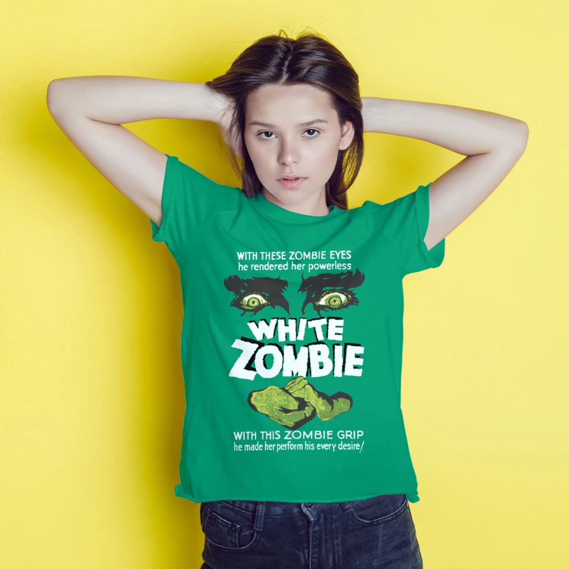 A young woman is wearing a green t-shirt with 'White Zombie' text and graphic design of a zombie on a yellow background
